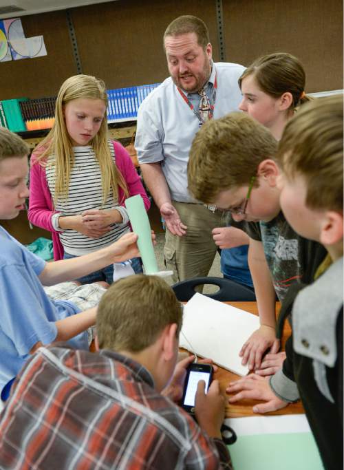 Francisco Kjolseth  |  The Salt Lake Tribune 
Brandon Engles, a teacher at Alpine School District's Shelley Elementary, checks in with his sixth-graders working out ideas for amplifying music vibrations. Engles has won an award from KUED and The Salt Lake Tribune for innovative teaching. Five Utah teachers have been selected for  the award.